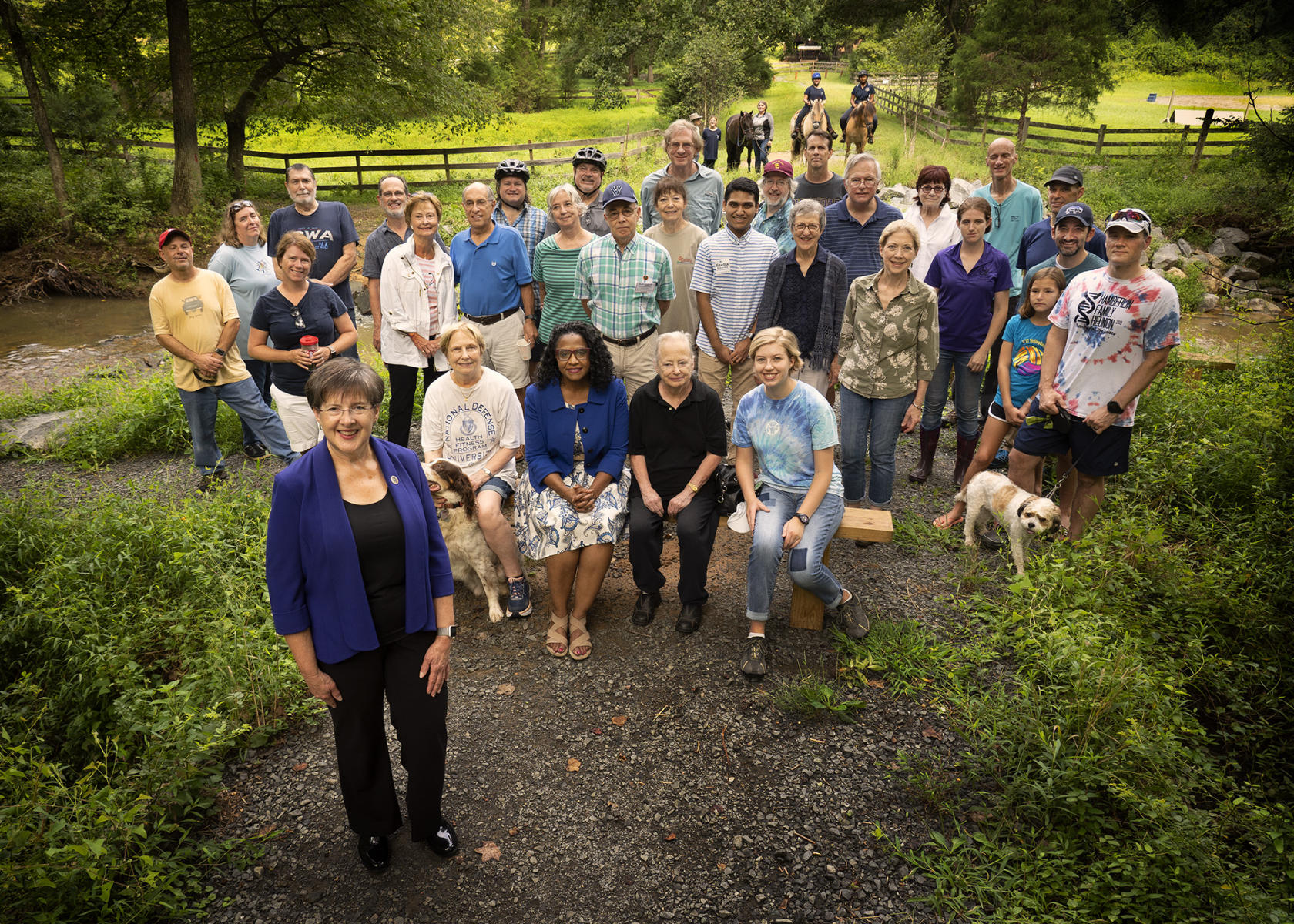 Kathy Smith and her supporters assembled in the wooded recreation area that lost a bridge that connected local communities. Without the bridge they were cut off and she was there to show her support for the repair of the bridge.